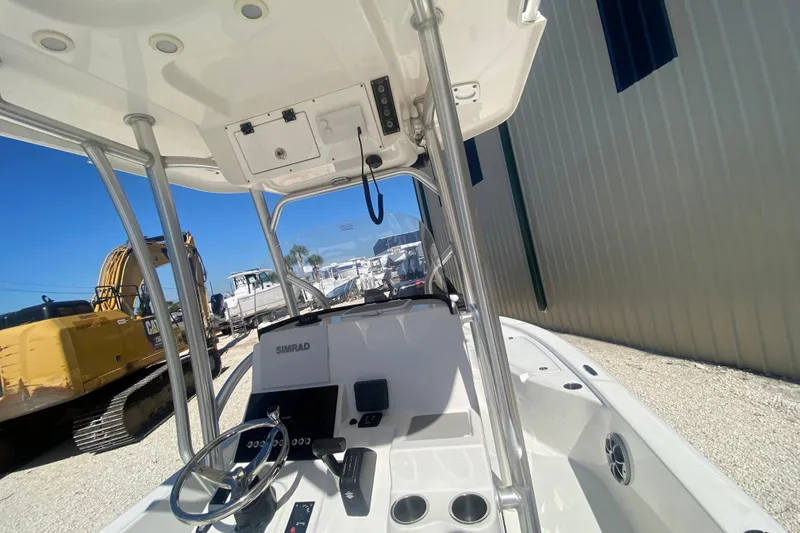 Slide: The Image of 2021 Sea Pro 248 Bay boat interior with steering console and Simrad electronics. - 4