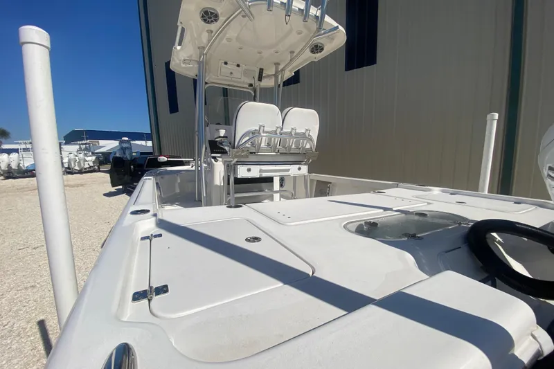 Slide: The Image of 2021 Sea Pro 248 Bay boat with T-top and dual seats, docked outdoors. - 6