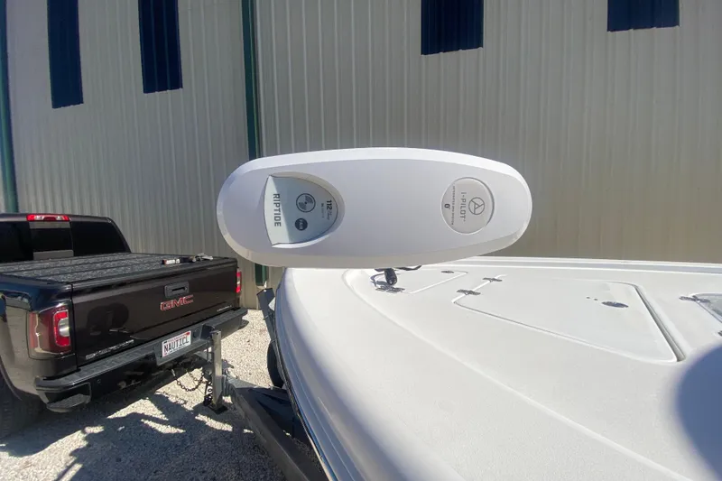 Slide: The Image of 2021 Sea Pro 248 Bay boat with i-Pilot trolling motor, parked near a GMC truck. - 9