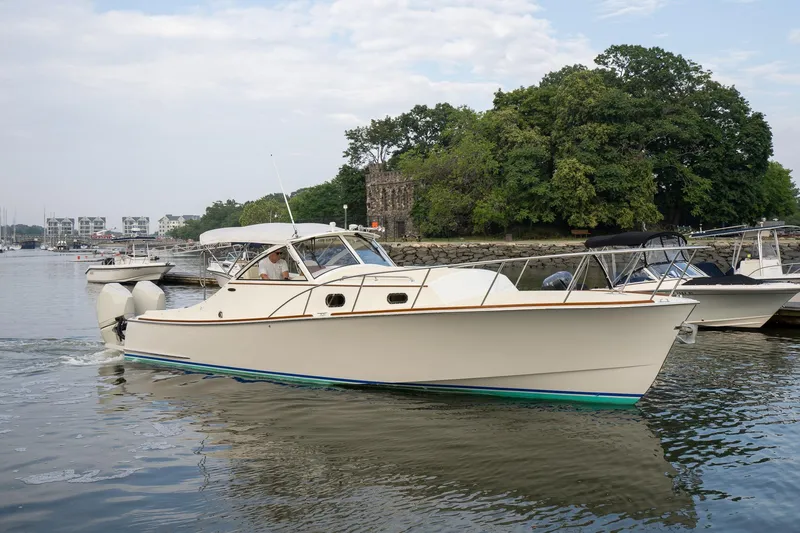 Slide: The Image of 2021 Brooklin Boat Yard 32 Express cruising on a calm river near a wooded shoreline. - 1
