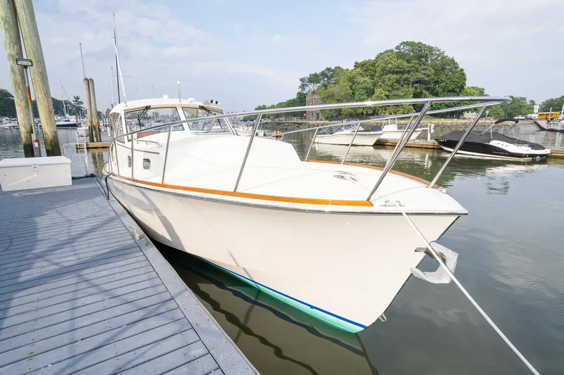Slide: The Image of 2021 Brooklin Boat Yard 32 Express docked at marina, calm water, clear sky. - 11