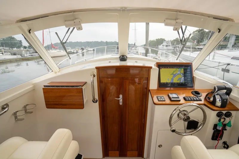 Slide: The Image of Interior view of 2021 Brooklin Boat Yard 32 Express helm with navigation equipment. - 20