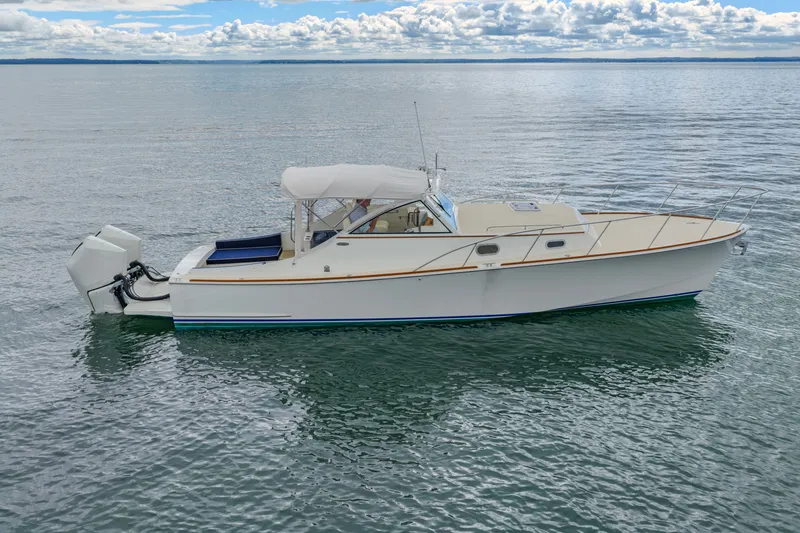 Slide: The Image of 2021 Brooklin Boat Yard 32 Express cruising on calm waters under a cloudy sky. - 35