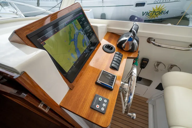 Slide: The Image of Control panel of 2021 Brooklin Boat Yard 32 Express with navigation screen and throttle. - 25