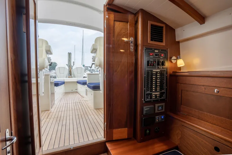 Slide: The Image of Interior view of 2021 Brooklin Boat Yard 32 Express, featuring wood paneling and control panel. - 32