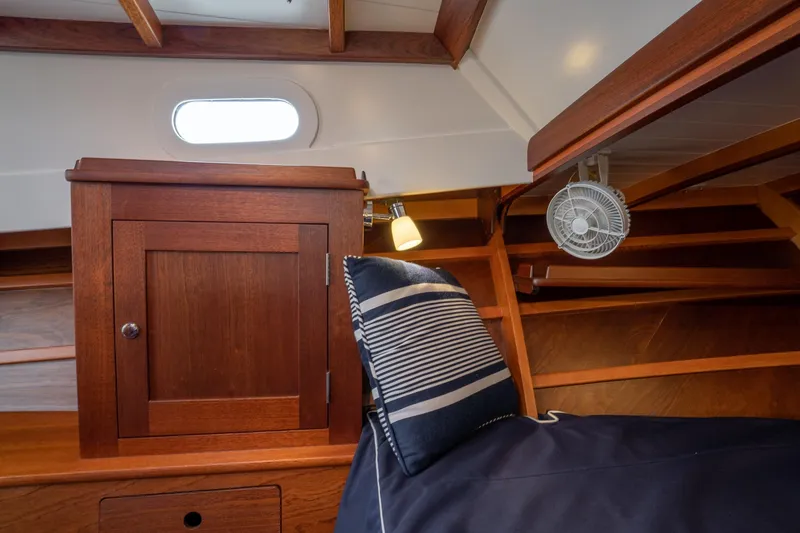 Slide: The Image of Interior of 2021 Brooklin Boat Yard 32 Express, featuring wooden cabinetry and nautical decor. - 36