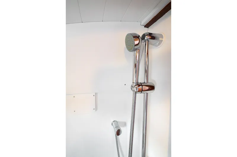 Slide: The Image of Shower area in 2021 Brooklin Boat Yard 32 Express, featuring chrome fixtures. - 38
