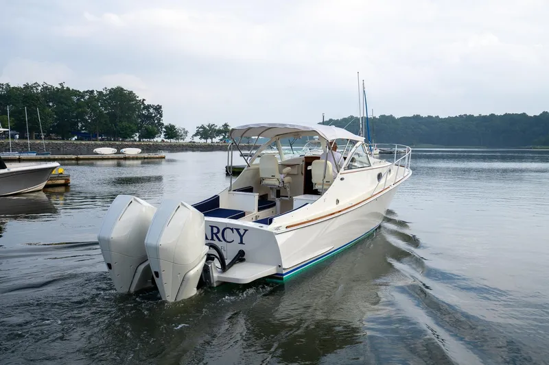 Slide: The Image of 2021 Brooklin Boat Yard 32 Express cruising on calm waters near a marina. - 4