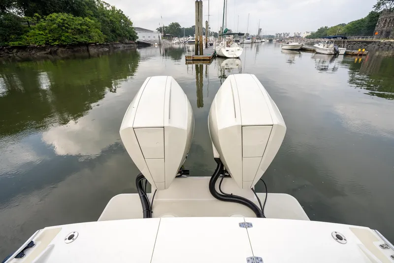 Slide: The Image of 2021 Brooklin Boat Yard 32 Express with dual engines in a serene marina setting. - 5