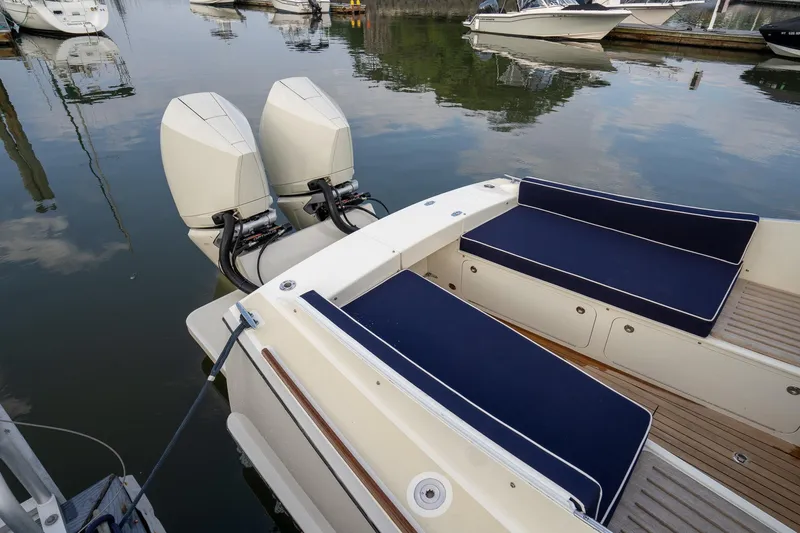 Slide: The Image of Brooklin Boat Yard 32 Express 2021 with twin engines and navy seating in a marina. - 6