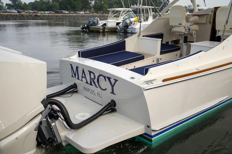 Slide: The Image of 2021 Brooklin Boat Yard 32 Express, named "Marcy," docked in calm waters. - 9