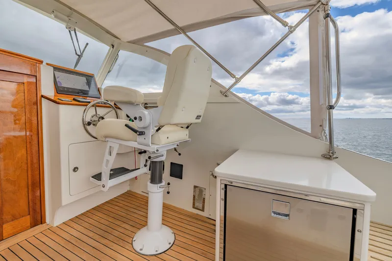Slide: The Image of Helm of 2021 Brooklin Boat Yard 32 Express with captain's chair and navigation equipment. - 13