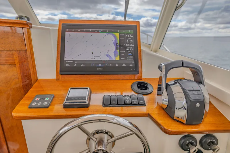 Slide: The Image of Helm of 2021 Brooklin Boat Yard 32 Express with navigation display and controls. - 15
