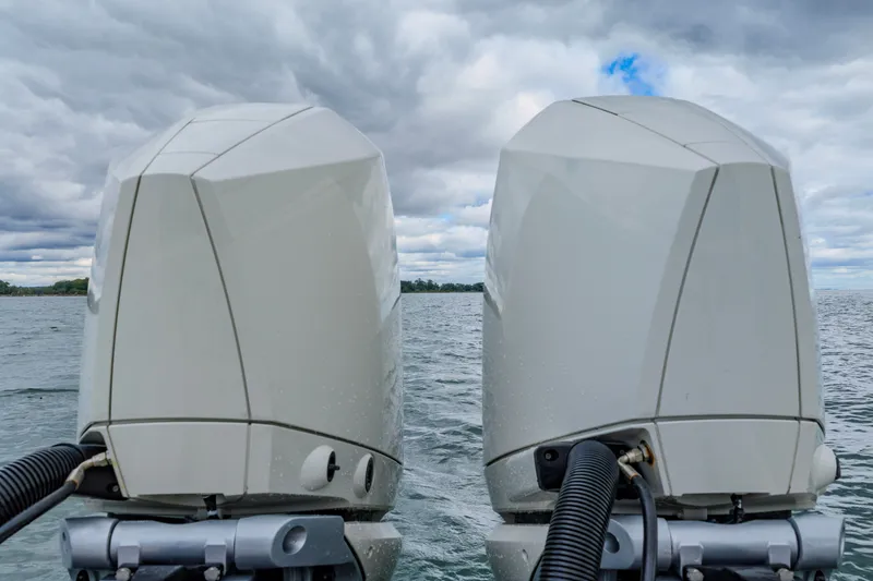 Slide: The Image of Twin outboard motors on a 2021 Brooklin Boat Yard 32 Express, against a cloudy seascape. - 34