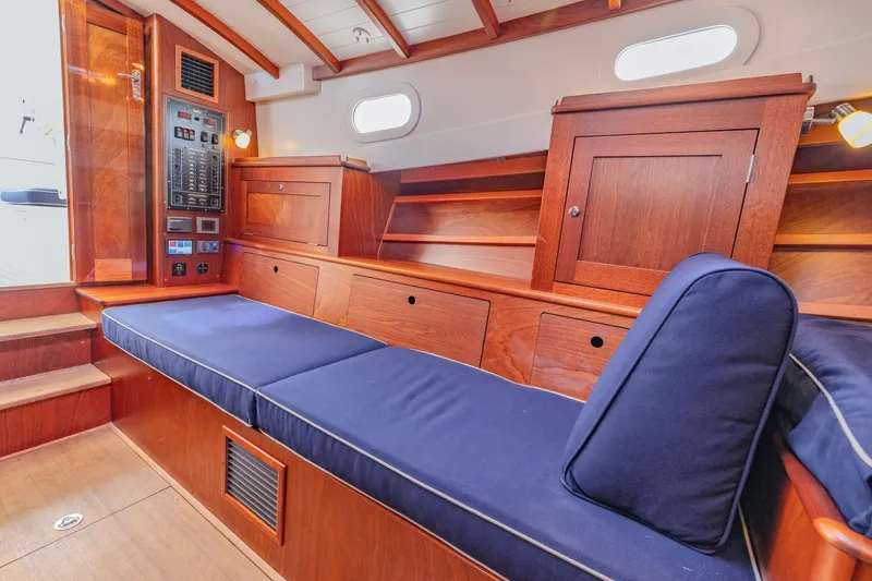 Slide: The Image of Luxurious interior of 2021 Brooklin Boat Yard 32 Express with wooden cabinetry and blue cushions. - 23