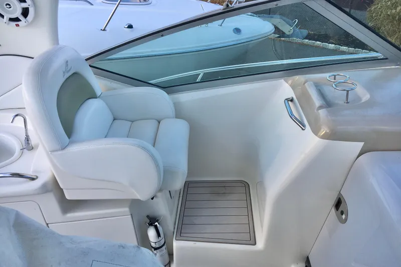 Slide: The Image of 2007 Sea Ray 340 Sundancer cockpit with white seating and cup holders. - 13