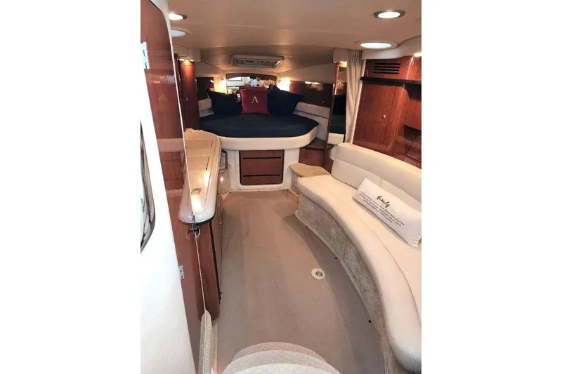 Slide: The Image of 2007 Sea Ray 340 Sundancer cabin interior with plush seating and elegant wood finishes. - 19