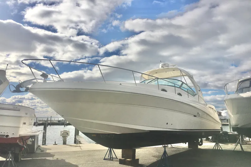 Slide: The Image of 2007 Sea Ray 340 Sundancer yacht on stands under a cloudy sky. - 2