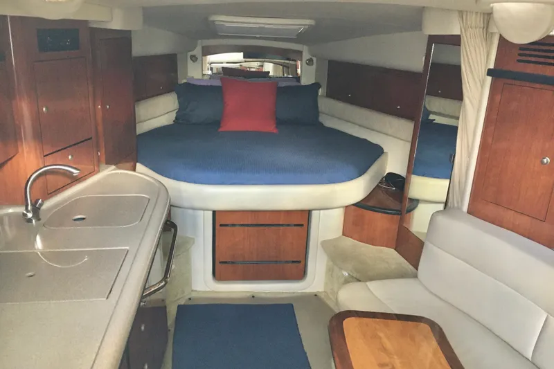 Slide: The Image of 2007 Sea Ray 340 Sundancer cabin interior with bed, kitchenette, and seating area. - 20
