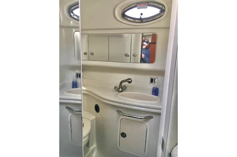 Slide: The Image of 2007 Sea Ray 340 Sundancer bathroom with sink, mirror, and oval window. - 26