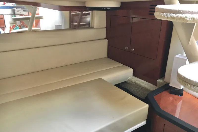 Slide: The Image of Interior of 2007 Sea Ray 340 Sundancer with beige seating and wooden cabinetry. - 30
