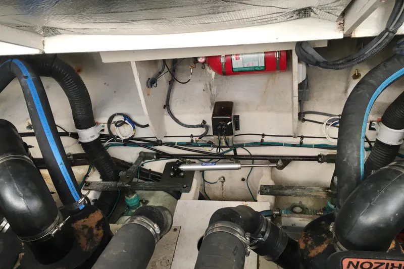 Slide: The Image of Engine compartment of 2007 Sea Ray 340 Sundancer with hoses and fire extinguisher. - 33
