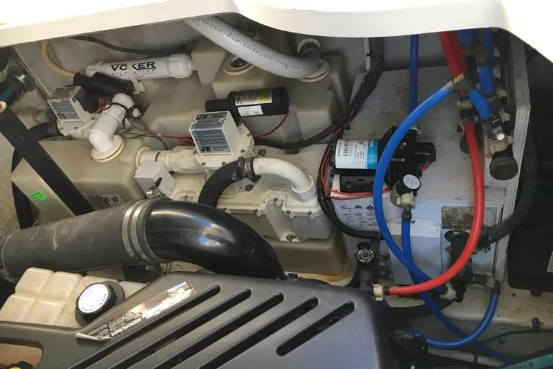 Slide: The Image of Engine compartment of 2007 Sea Ray 340 Sundancer with visible hoses and components. - 36