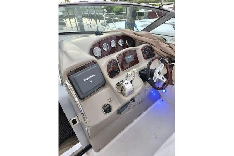 Slide: The Image of 2007 Sea Ray 340 Sundancer helm with Raymarine navigation and modern controls. - 7