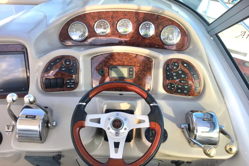 Slide: The Image of 2007 Sea Ray 340 Sundancer helm with wood accents and modern controls. - 9