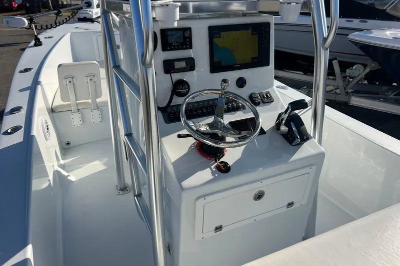 Slide: The Image of 2024 Andros Tarpon 26 boat console with steering wheel and navigation equipment. - 11