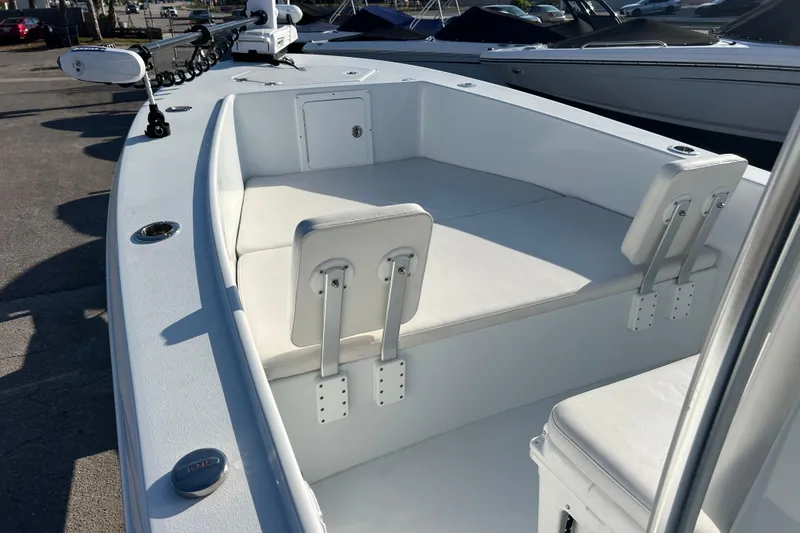 Slide: The Image of 2024 Andros Tarpon 26 boat interior with white seating and storage compartments. - 13