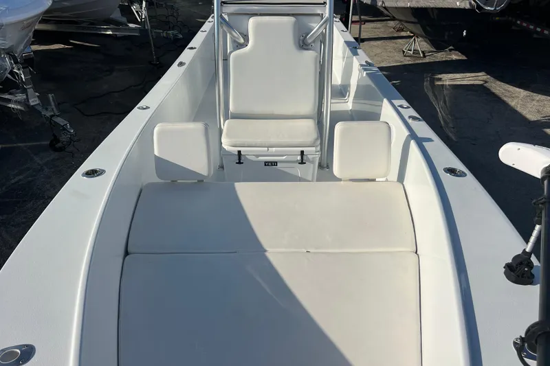 Slide: The Image of 2024 Andros Tarpon 26 boat interior with white seating and console. - 18