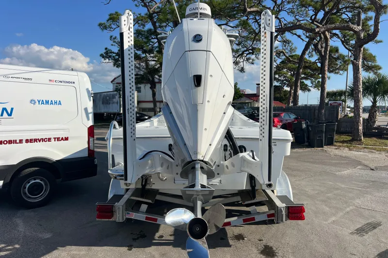 Slide: The Image of 2024 Andros Tarpon 26 boat on trailer, rear view, with Yamaha service van nearby. - 6