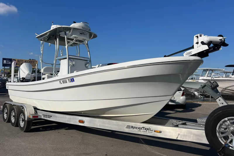 The Image of 2024 Andros Tarpon 26 boat on trailer under clear blue sky. - 1