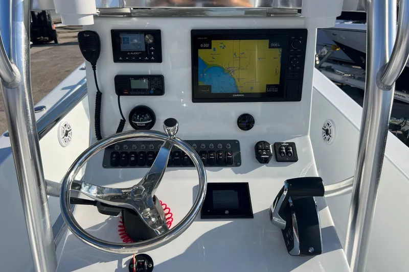 Slide: The Image of 2024 Andros Tarpon 26 boat dashboard with navigation system and controls. - 12
