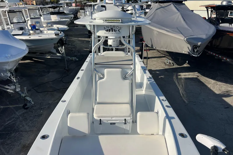 Slide: The Image of 2024 Andros Tarpon 26 boat, white interior, docked among other boats. - 19