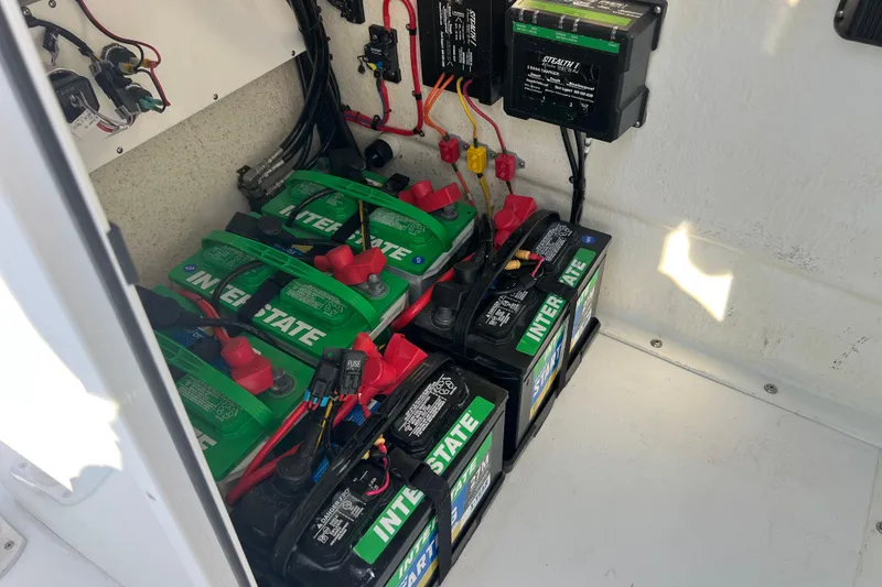 Slide: The Image of Battery compartment of 2024 Andros Tarpon 26 with Interstate batteries and wiring setup. - 20