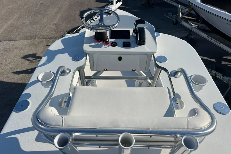 Slide: The Image of 2024 Andros Tarpon 26 boat console with steering wheel and seating. - 22