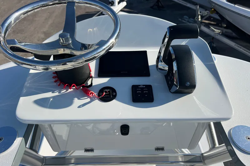 Slide: The Image of 2024 Andros Tarpon 26 boat console with steering wheel and controls. - 23