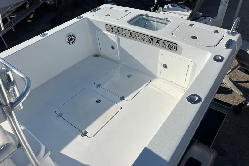 Slide: The Image of 2024 Andros Tarpon 26 boat deck with storage compartments and measurement scale. - 26