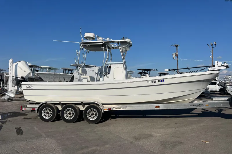 Slide: The Image of 2024 Andros Tarpon 26 boat on a trailer under clear blue sky. - 3