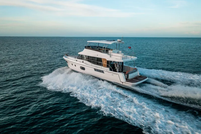 The Image of 2026 Beneteau Swift Trawler 48 cruising on open sea, showcasing sleek design and performance. - 1