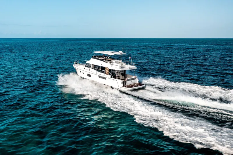 Slide: The Image of 2026 Beneteau Swift Trawler 48 cruising on open ocean waters. - 16
