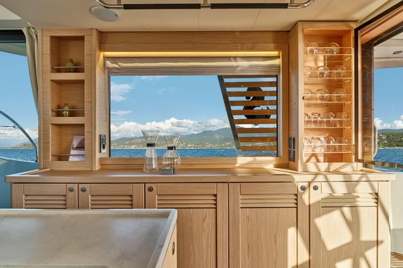 Slide: The Image of Luxurious interior of 2026 Beneteau Swift Trawler 48 with ocean view and elegant wood cabinetry. - 38