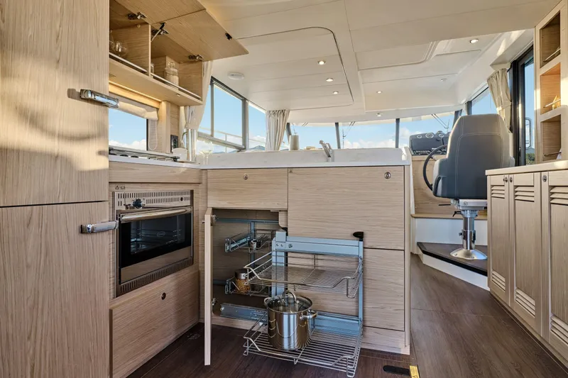 Slide: The Image of Modern kitchen interior of 2026 Beneteau Swift Trawler 48 with sleek wood cabinetry. - 45