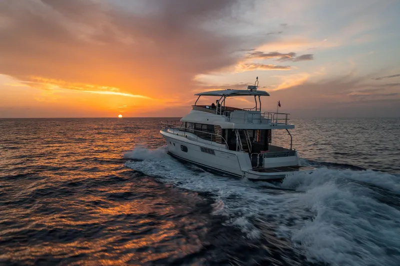 Slide: The Image of 2026 Beneteau Swift Trawler 48 cruising at sunset on open sea. - 6