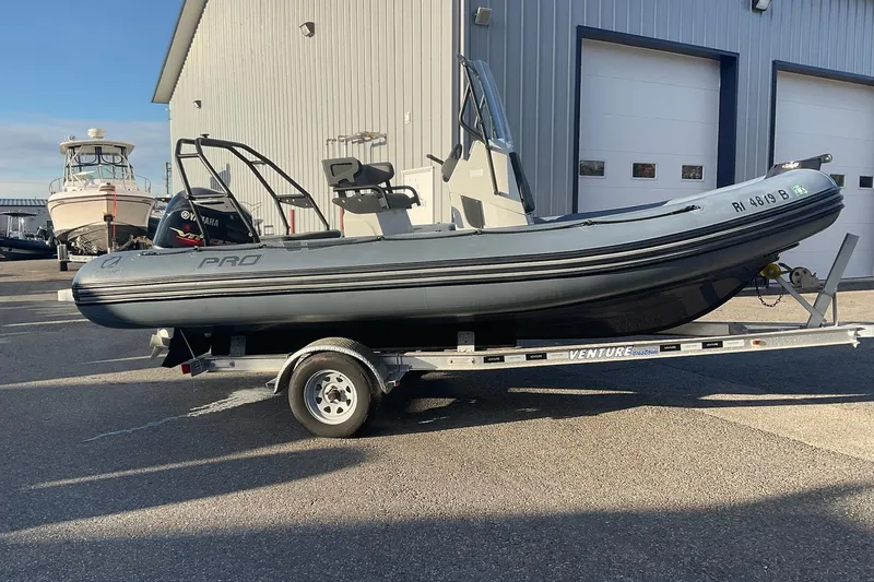 The Image of 2020 Zodiac Pro 5.5 boat on trailer, parked outside a warehouse. - 0