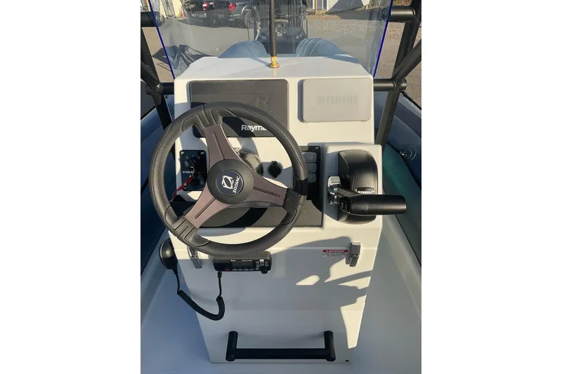 Slide: The Image of 2020 Zodiac Pro 5.5 boat dashboard with steering wheel and controls. - 3
