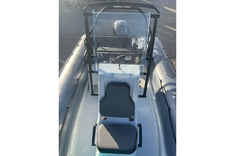 Slide: The Image of 2020 Zodiac Pro 5.5 boat interior with steering console and seating. - 4