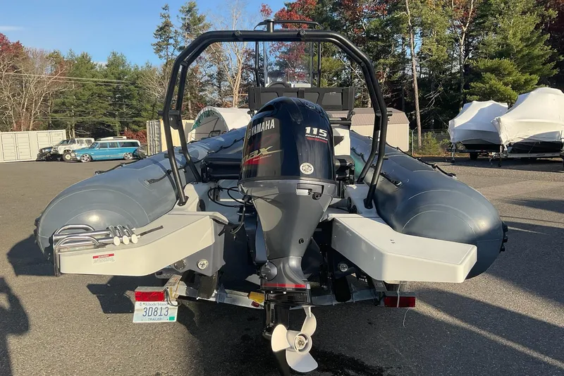 Slide: The Image of 2020 Zodiac Pro 5.5 boat with Yamaha 115 engine, parked outdoors. - 5